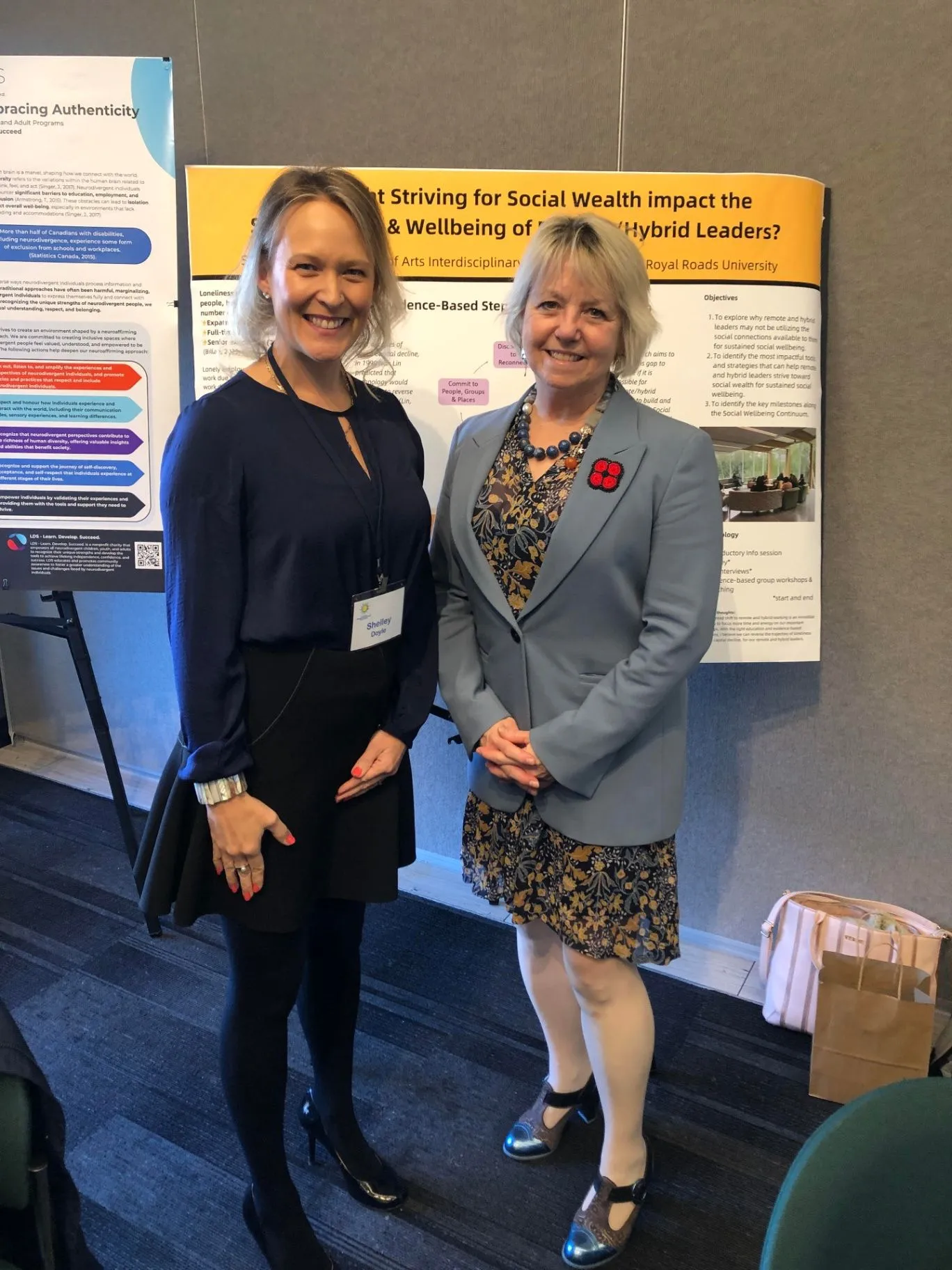Shelley Doyle presenting the Social Wealth research poster with Dr Bonnie Henry at the Canadian Human Connection Conference